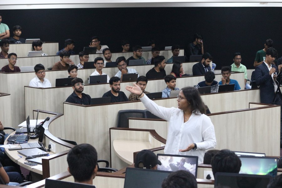 Shambhavi Gupta speaking to a full lecture theatre of students at NMIMS
